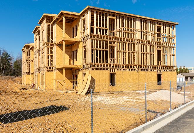 a job site enclosed by temporary chain link fences, ensuring safety for workers and pedestrians in Elm Grove, WI